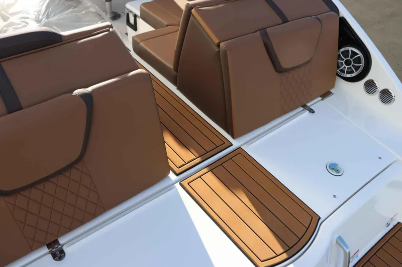 Slide: The Image of 2025 Yamaha Boats 222S interior with brown seating and teak-style flooring. - 6