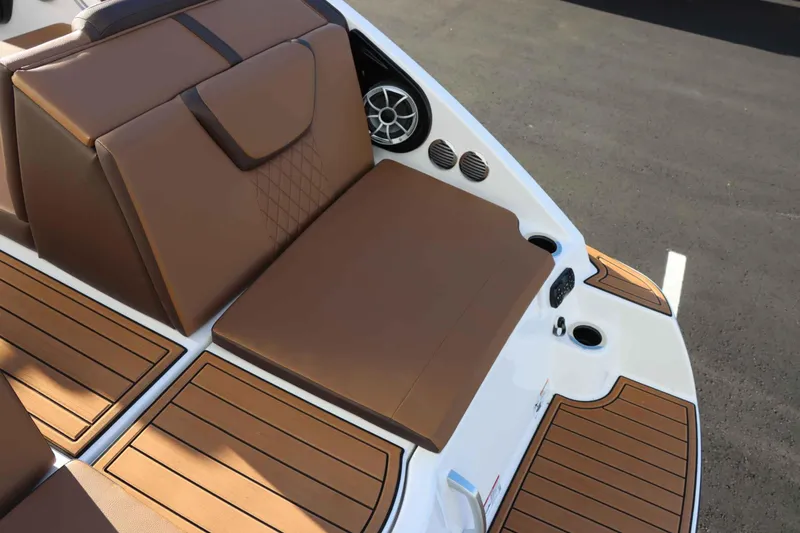 Slide: The Image of 2025 Yamaha Boats 222S interior with brown seating and teak-style flooring. - 8