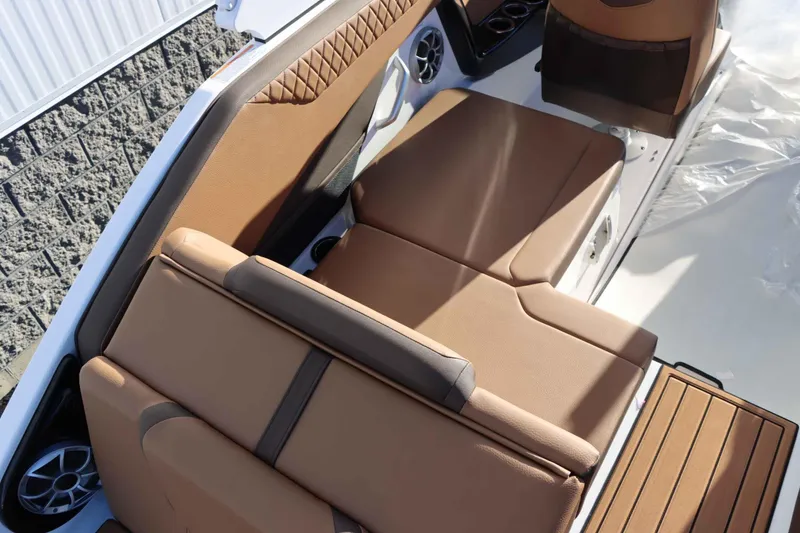 Slide: The Image of 2025 Yamaha Boats 222S interior with tan seating and modern design. - 9