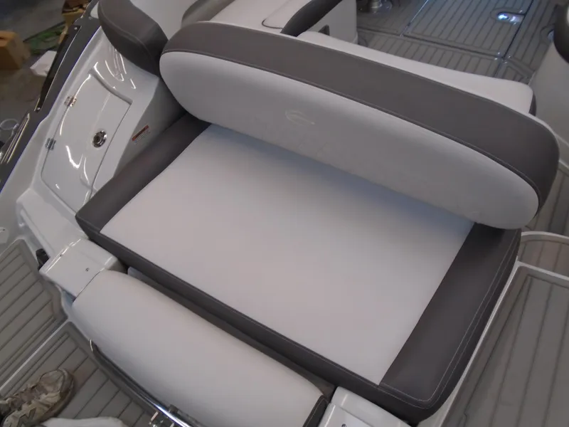 Slide: The Image of 2024 Crownline E 235 Surf boat seat with gray and white upholstery. - 11