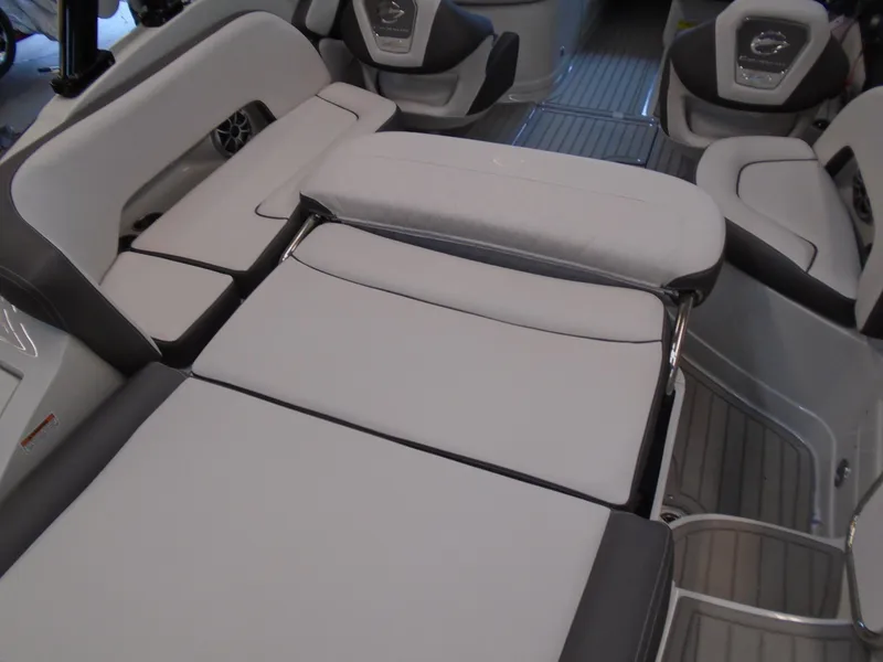 Slide: The Image of 2024 Crownline E 235 Surf boat interior with cushioned seating and modern design. - 12
