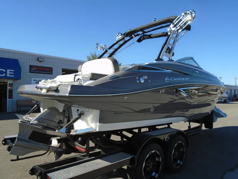 Slide: The Image of 2024 Crownline E 235 Surf boat on trailer, sleek design, gray exterior. - 4