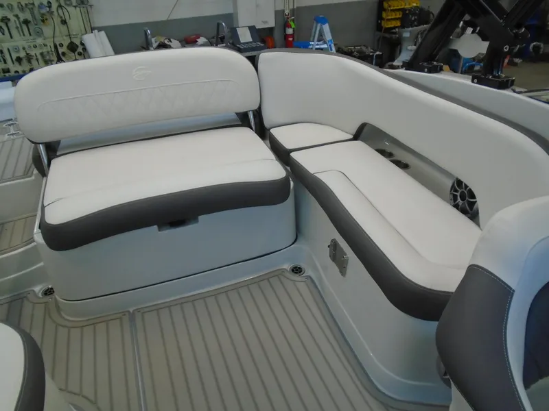 Slide: The Image of 2024 Crownline E 235 Surf boat interior with white and gray seating. - 9
