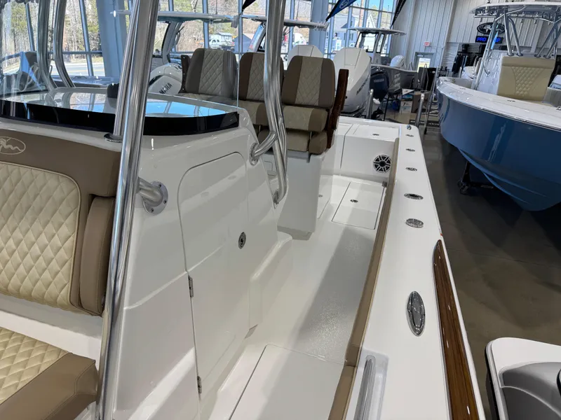 Slide: The Image of 2025 Valhalla Boatworks V-29 interior with cushioned seating and sleek design in showroom. - 15