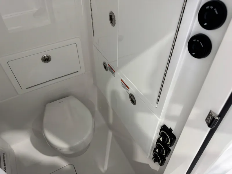 Slide: The Image of 2025 Valhalla Boatworks V-29 interior bathroom with modern fixtures and storage compartments. - 17