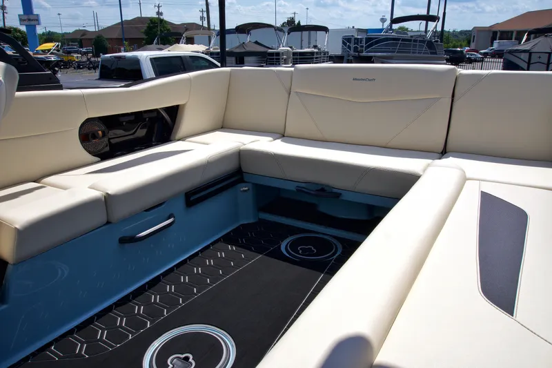 Slide: The Image of 2024 MasterCraft NXT23 boat interior with beige seating and modern design. - 14