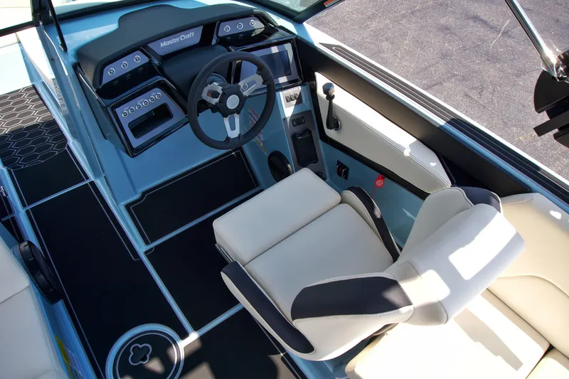 Slide: The Image of 2024 MasterCraft NXT23 boat interior with modern dashboard and comfortable seating. - 16