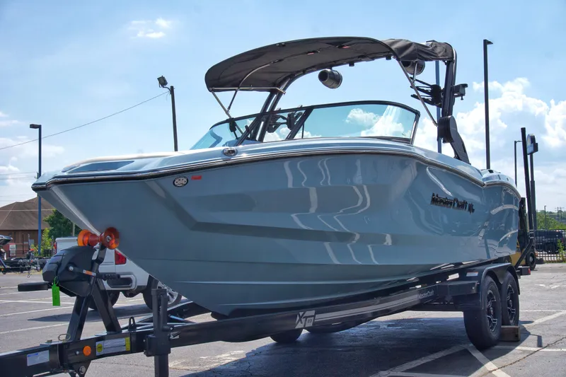 Slide: The Image of 2024 MasterCraft NXT23 boat on trailer in parking lot. - 8