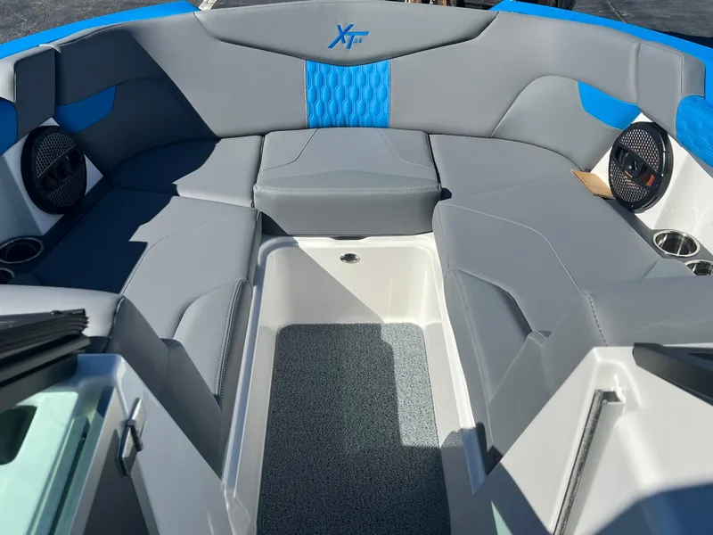Slide: The Image of 2024 MasterCraft XT24 boat interior with gray and blue seating. - 12
