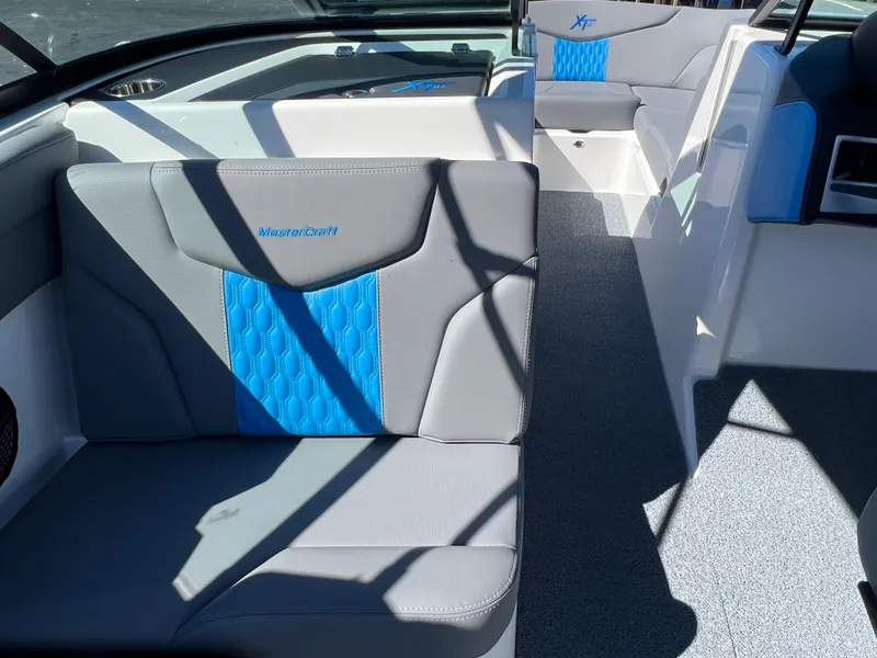 Slide: The Image of 2024 MasterCraft XT24 boat interior with gray and blue seating. - 14