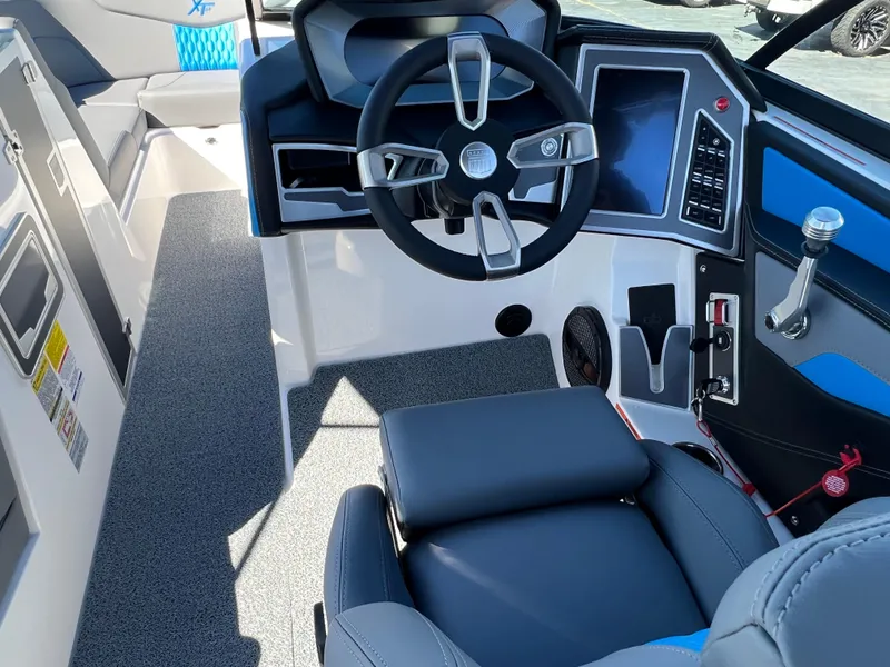 Slide: The Image of 2024 MasterCraft XT24 boat interior with modern steering and dashboard controls. - 15