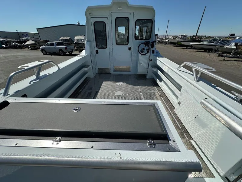 Slide: The Image of 2024 Hewescraft 270 Alaskan boat interior with spacious deck and cabin. - 9