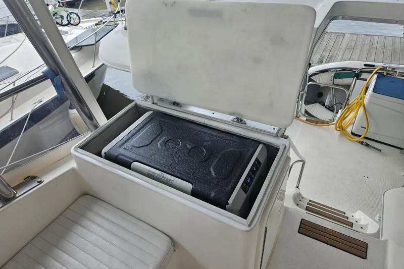 Slide: The Image of Open storage compartment on 1999 Riviera 40AC boat deck. - 12