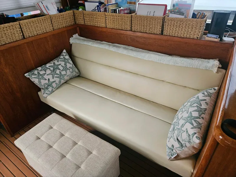 Slide: The Image of Cream leather sofa with starfish pillows on a 1999 Riviera 40AC boat. - 14