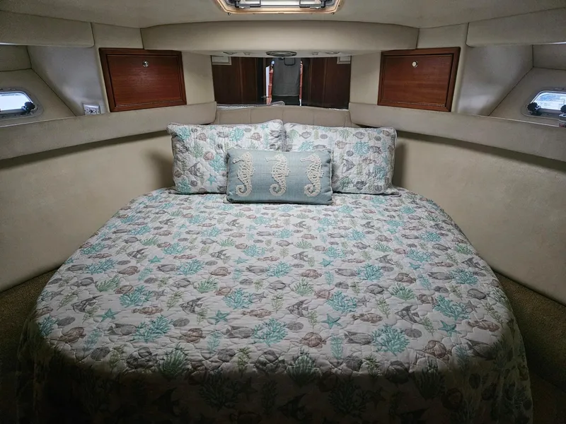 Slide: The Image of Cozy bedroom in 1999 Riviera 40AC yacht with nautical-themed bedding. - 17