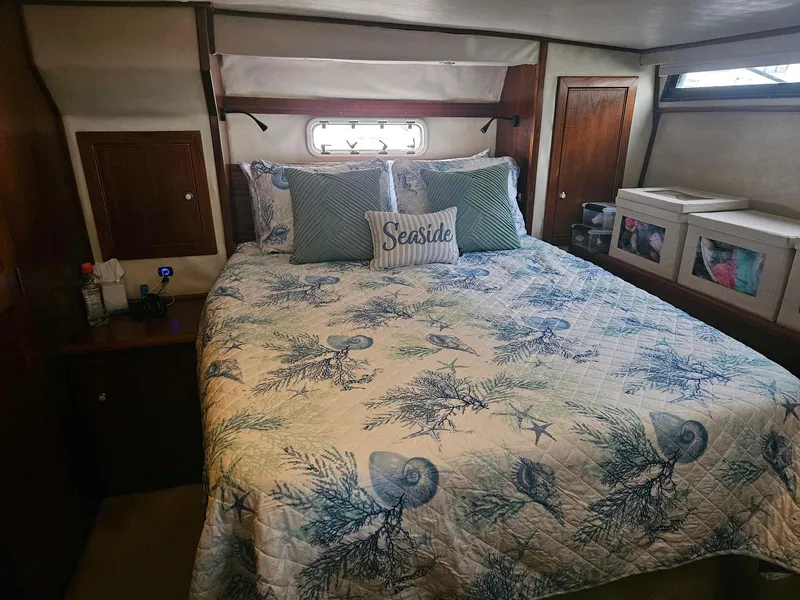 Slide: The Image of Cozy bedroom in 1999 Riviera 40AC yacht with nautical-themed bedding. - 19