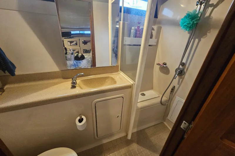 Slide: The Image of 1999 Riviera 40AC yacht bathroom with shower, sink, and mirror. - 20