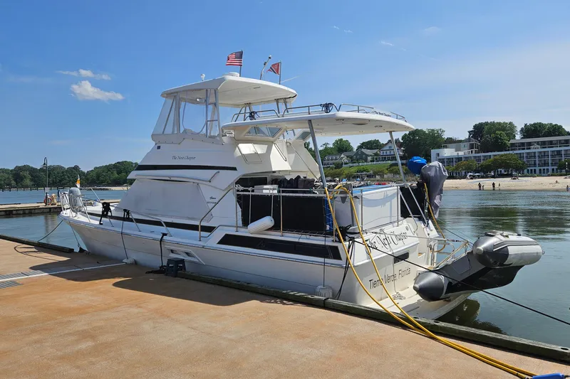 Slide: The Image of 1999 Riviera 40AC yacht docked at marina with clear blue sky. - 4