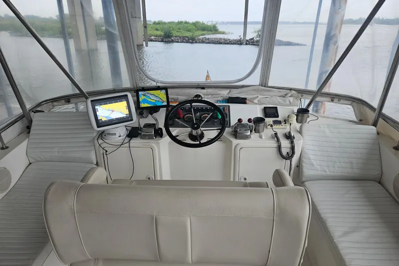 Slide: The Image of Cockpit of 1999 Riviera 40AC yacht with navigation equipment and panoramic water view. - 8