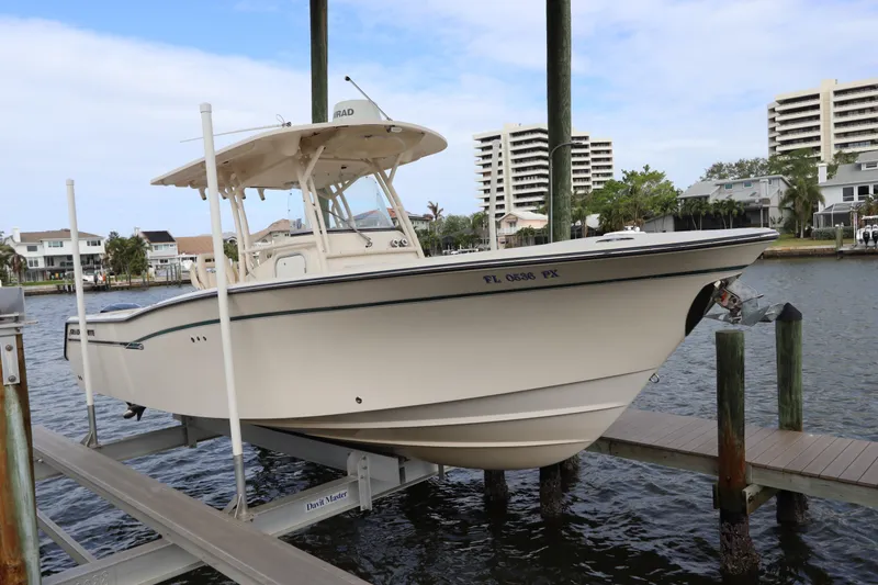 Slide: The Image of 2015 Grady-White Canyon 306 boat on lift, docked in marina. - 0