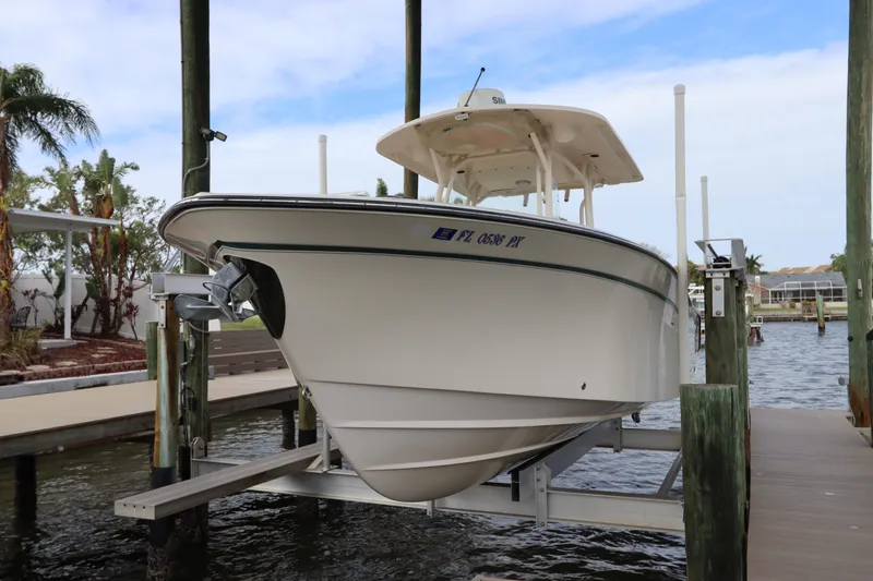 Slide: The Image of 2015 Grady-White Canyon 306 boat on lift, docked by waterfront. - 1