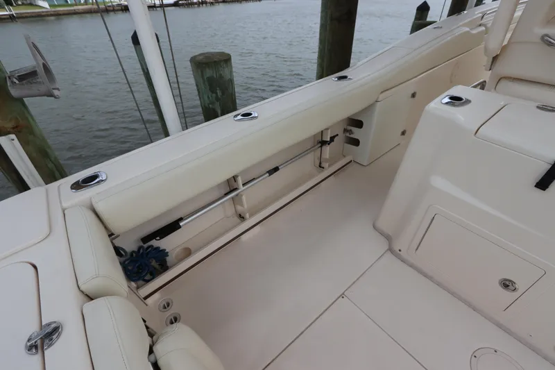 Slide: The Image of 2015 Grady-White Canyon 306 boat interior with seating and storage near dock. - 12
