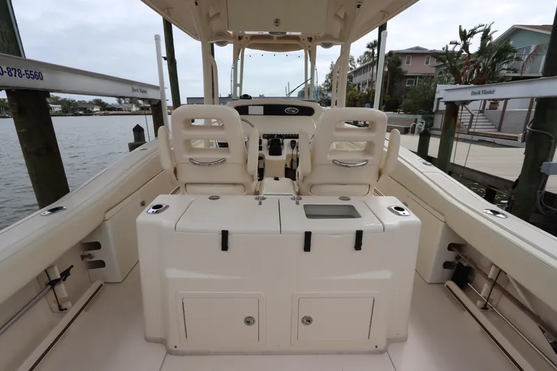Slide: The Image of 2015 Grady-White Canyon 306 boat interior, featuring dual seats and storage compartments. - 14