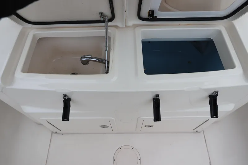 Slide: The Image of 2015 Grady-White Canyon 306 boat sink and storage compartments. - 15