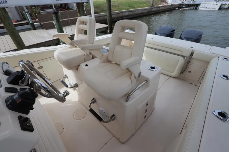 Slide: The Image of 2015 Grady-White Canyon 306 boat interior with dual captain's chairs and steering wheel. - 17