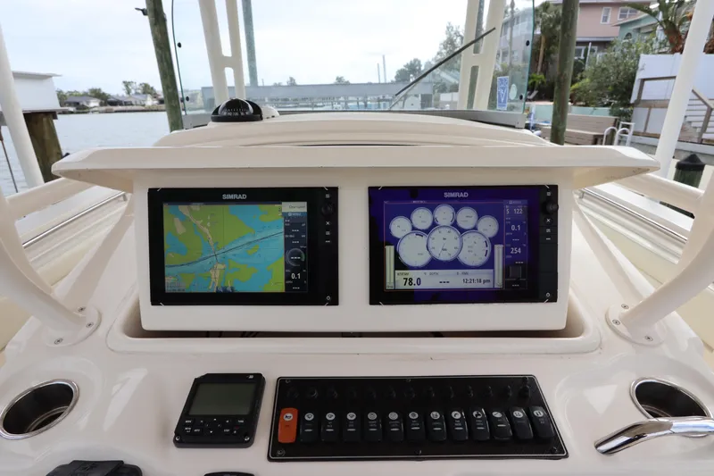 Slide: The Image of 2015 Grady-White Canyon 306 dashboard with navigation and control panels. - 19