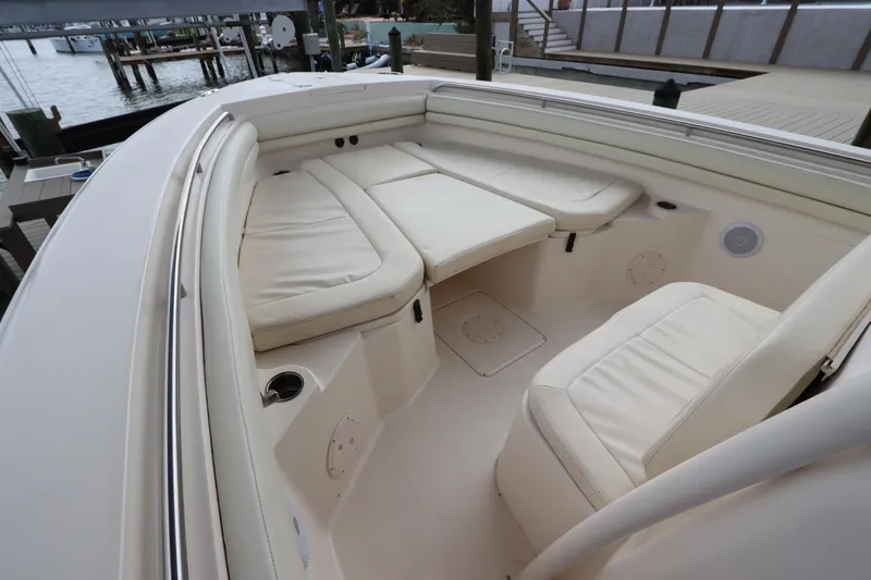 Slide: The Image of 2015 Grady-White Canyon 306 boat interior with cushioned seating and cup holders. - 28