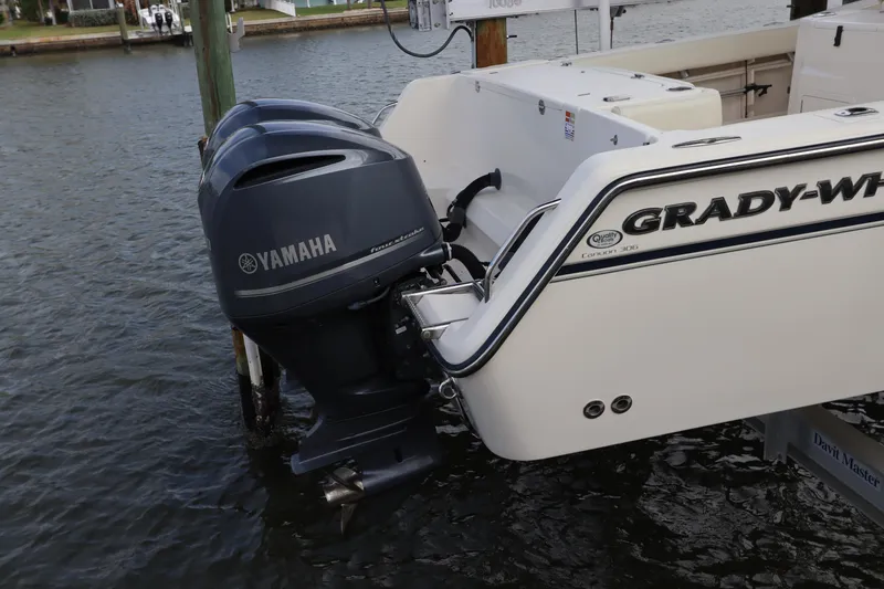 Slide: The Image of 2015 Grady-White Canyon 306 boat with Yamaha outboard motors docked in water. - 3