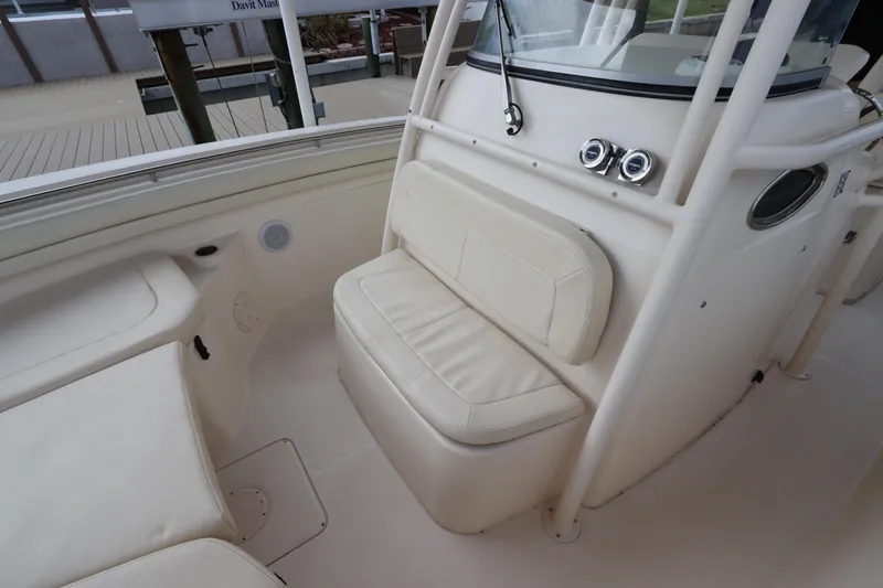 Slide: The Image of 2015 Grady-White Canyon 306 boat interior with cushioned seating and console. - 30