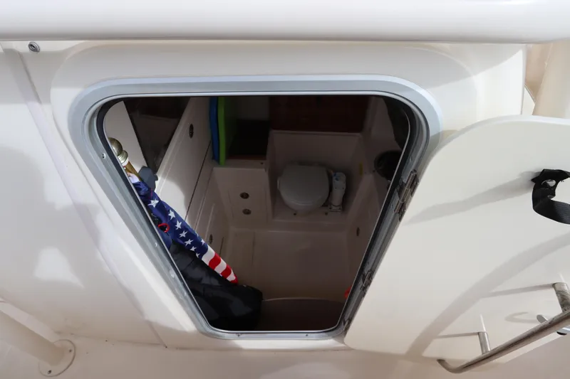 Slide: The Image of Interior view of 2015 Grady-White Canyon 306 boat cabin with toilet and American flag. - 31