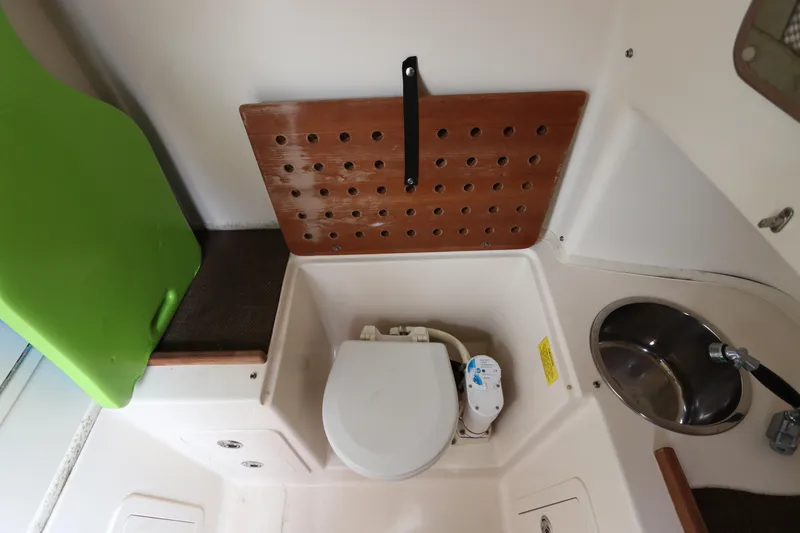 Slide: The Image of 2015 Grady-White Canyon 306 boat interior with toilet and sink. - 32