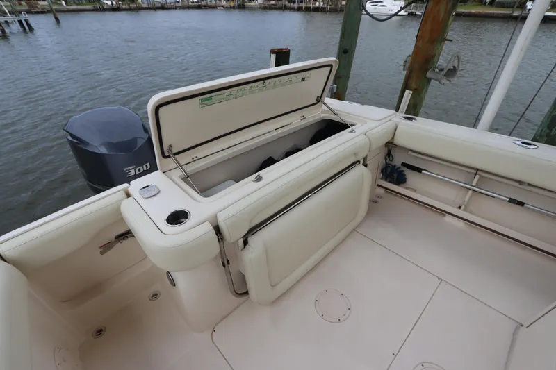 Slide: The Image of 2015 Grady-White Canyon 306 boat deck with open storage compartment and outboard motor. - 9