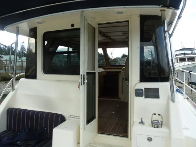 Slide: The Image of 2006 Sabre 38 Express yacht with open cabin door and striped seating. - 10