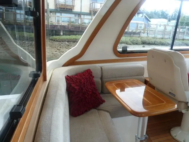 Slide: The Image of Interior of 2006 Sabre 38 Express yacht with cozy seating and wooden table. - 11