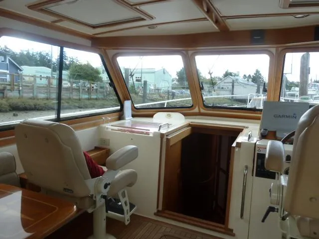 Slide: The Image of Interior of 2006 Sabre 38 Express boat with helm and seating area. - 12