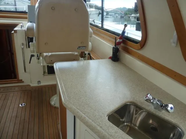 Slide: The Image of 2006 Sabre 38 Express interior with helm seat, countertop, and sink. - 13