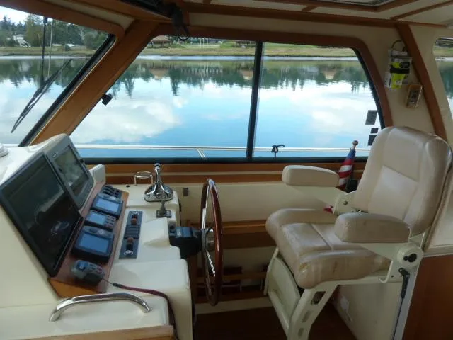 Slide: The Image of Interior of 2006 Sabre 38 Express boat with helm, controls, and captain's chair. - 18