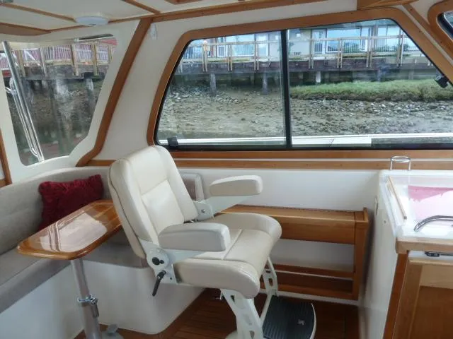 Slide: The Image of Interior of 2006 Sabre 38 Express boat with seating and window view. - 19