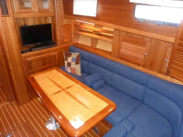 Slide: The Image of Luxurious interior of 2006 Sabre 38 Express yacht with blue seating and wooden finishes. - 21
