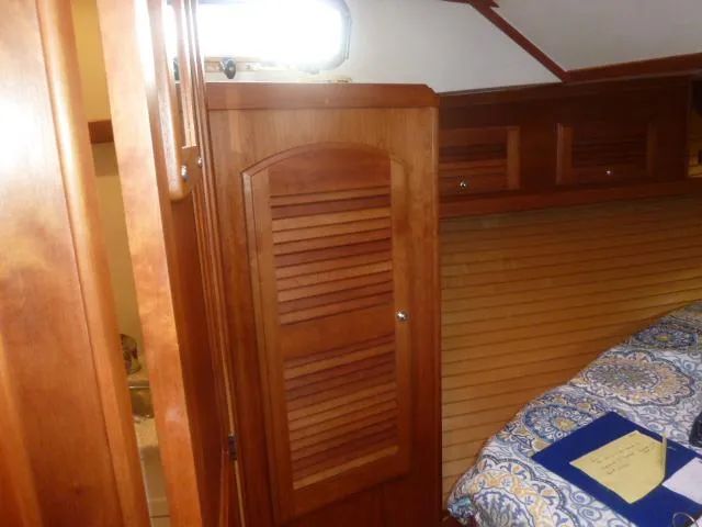 Slide: The Image of Interior cabin of 2006 Sabre 38 Express with wooden cabinetry and patterned bedding. - 24