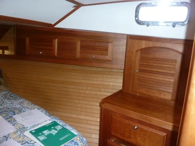 Slide: The Image of 2006 Sabre 38 Express cabin interior with wooden cabinetry and bed. - 25