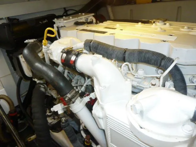 Slide: The Image of Engine compartment of a 2006 Sabre 38 Express boat, showcasing mechanical components. - 27