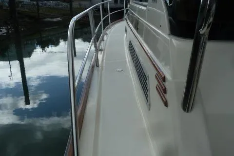 Slide: The Image of 2006 Sabre 38 Express yacht deck with railing, reflecting water surface. - 3