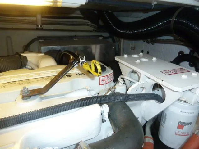 Slide: The Image of Engine compartment of a 2006 Sabre 38 Express boat, showcasing mechanical components and wiring. - 33
