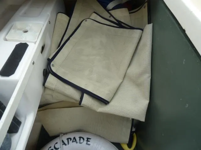 Slide: The Image of Folded beige canvas covers in a storage compartment of a 2006 Sabre 38 Express boat. - 39