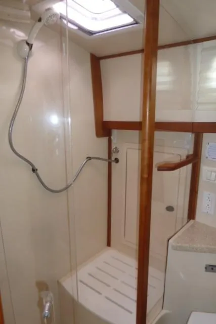 Slide: The Image of 2006 Sabre 38 Express yacht bathroom with shower and wooden accents. - 46